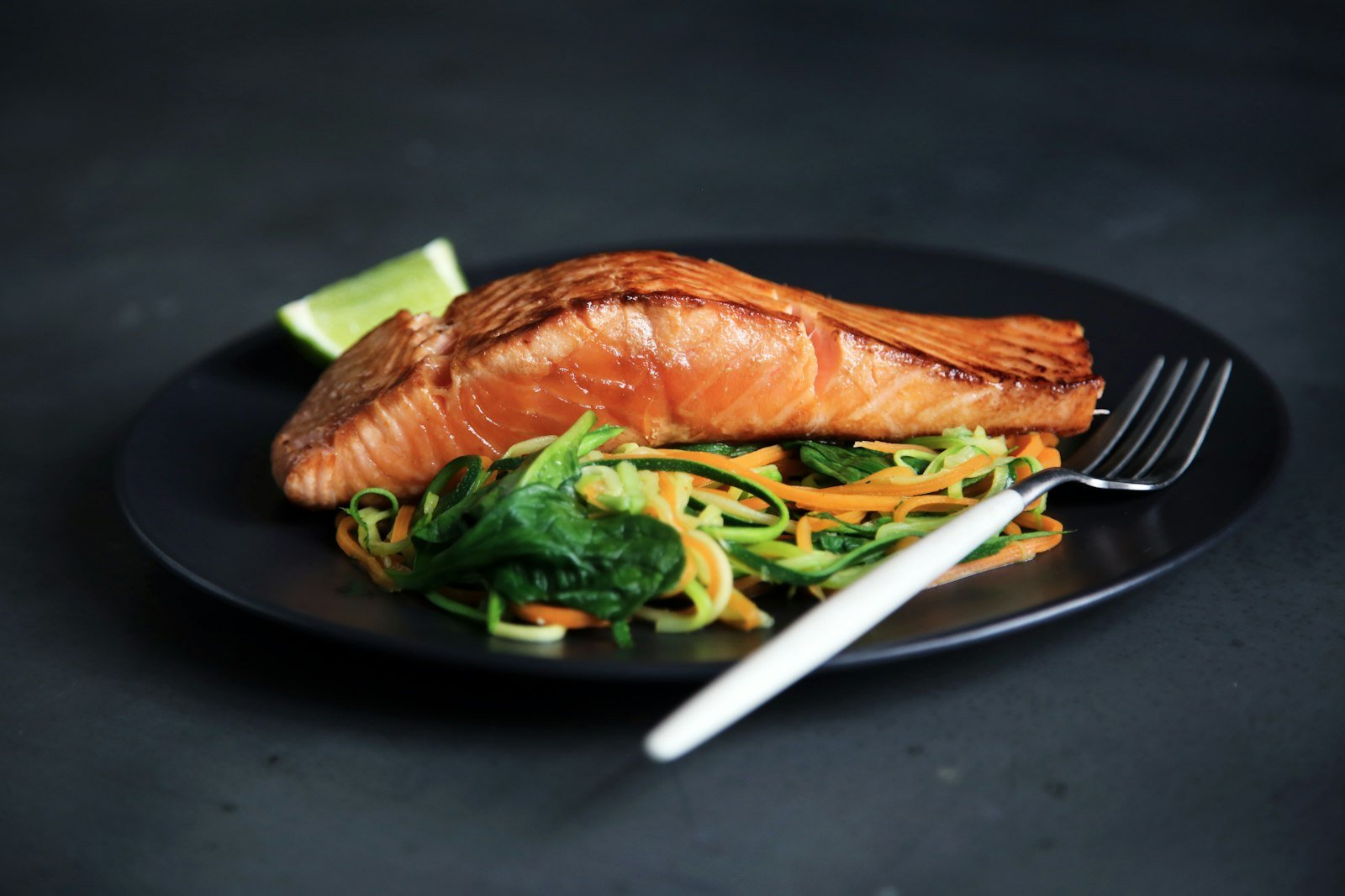 Grilled fish served with cooked vegetables